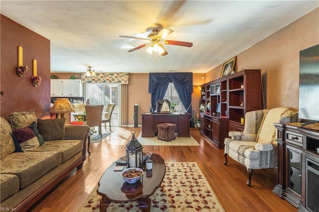 living room featuring ceiling fan and light hardwood / wood-style floors