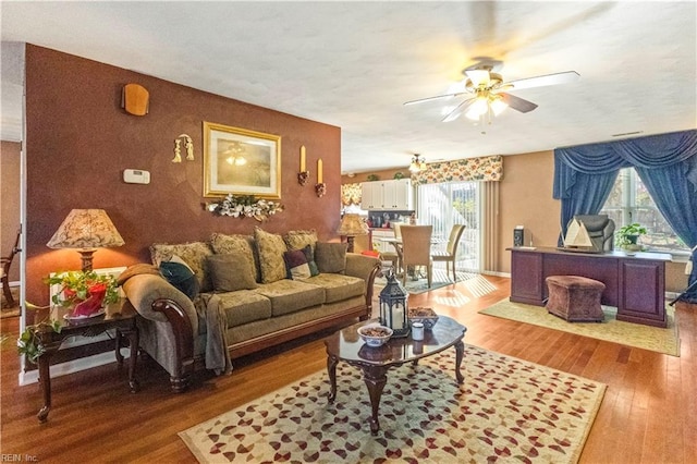 living room with hardwood / wood-style floors, plenty of natural light, and ceiling fan