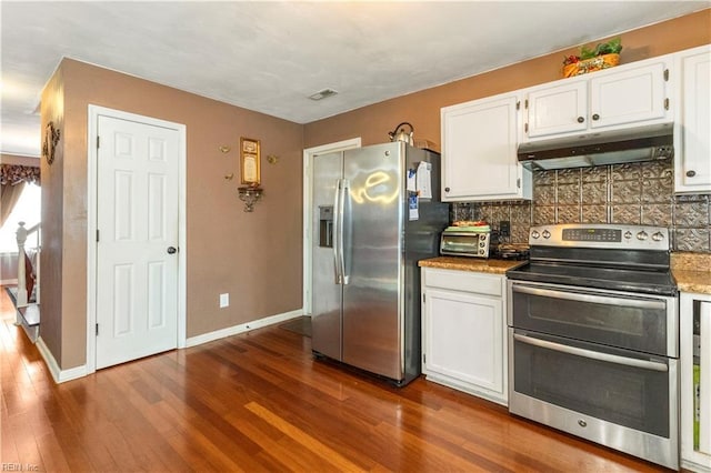 kitchen with white cabinetry, stainless steel appliances, dark wood-type flooring, and tasteful backsplash