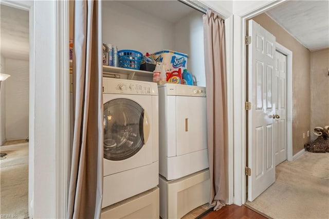 clothes washing area featuring carpet and separate washer and dryer