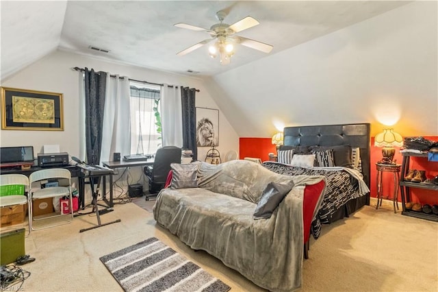 carpeted bedroom with ceiling fan and vaulted ceiling