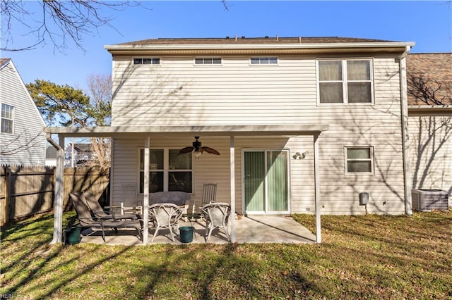 rear view of property featuring ceiling fan, a yard, a patio, and central AC unit