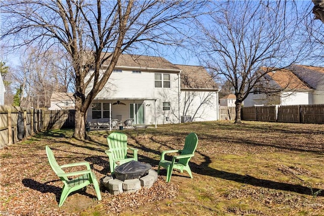 rear view of house featuring a fire pit, ceiling fan, cooling unit, and a patio area