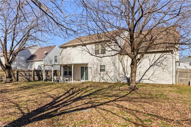 rear view of property featuring a patio area and a yard