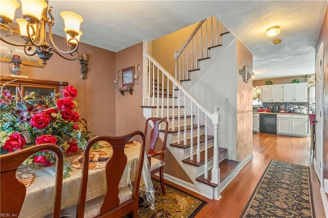 dining room with a chandelier and light hardwood / wood-style floors