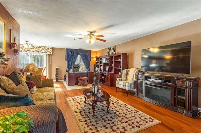 living room with light hardwood / wood-style flooring and ceiling fan