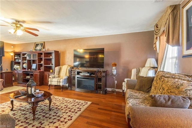 living room featuring a fireplace, ceiling fan, and hardwood / wood-style floors