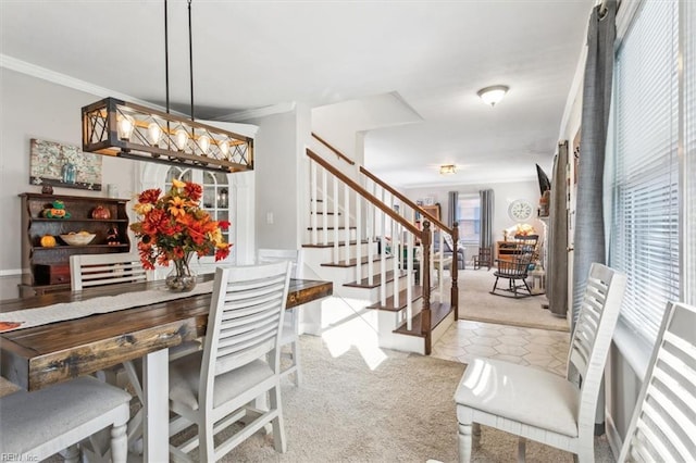 dining room featuring light tile patterned floors and crown molding