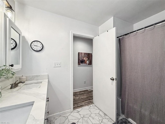 bathroom featuring curtained shower and vanity