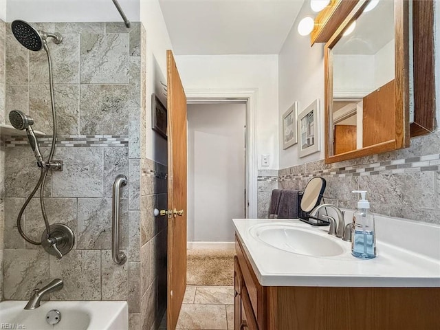 bathroom featuring vanity and tiled shower / bath