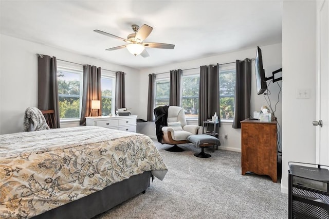 carpeted bedroom with ceiling fan and multiple windows