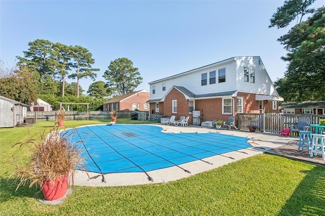 view of swimming pool with a patio and a lawn