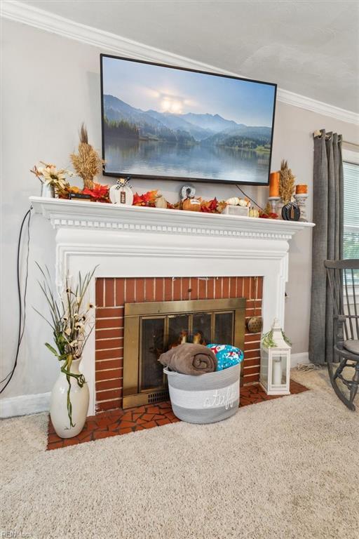 details with crown molding and a brick fireplace