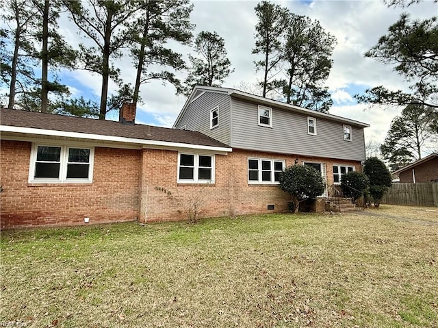 rear view of house with a lawn