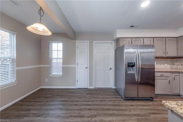 kitchen with gray cabinets, decorative light fixtures, stainless steel fridge, and tasteful backsplash