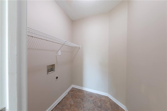 laundry area featuring washer hookup, hookup for an electric dryer, and a textured ceiling