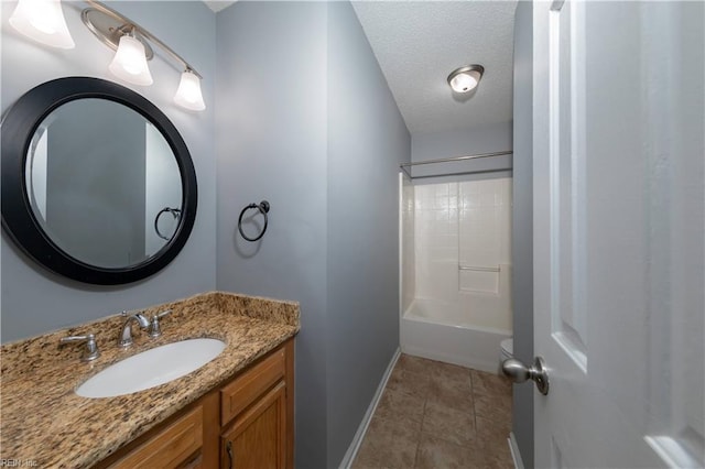 bathroom with vanity, a textured ceiling, and bathing tub / shower combination