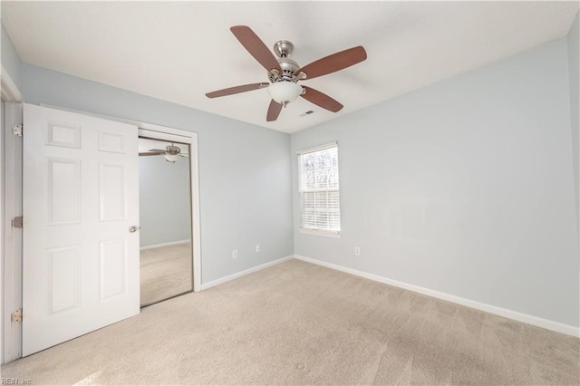 unfurnished bedroom with light carpet, a closet, and ceiling fan