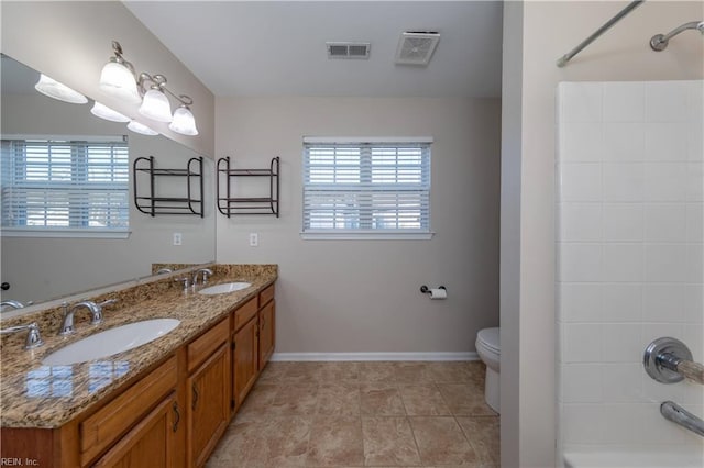 bathroom with tile patterned floors, vanity, and toilet