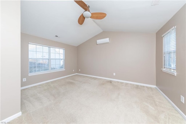 carpeted empty room with a wall unit AC, ceiling fan, and lofted ceiling