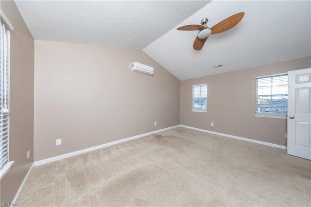 carpeted spare room with lofted ceiling, ceiling fan, and a wall mounted air conditioner