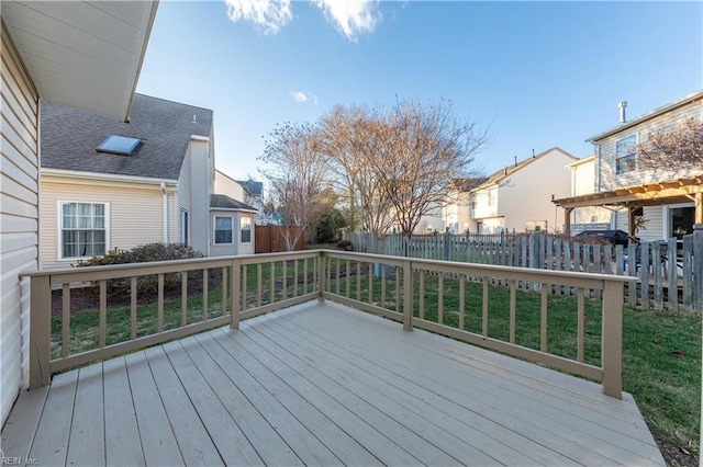 wooden terrace featuring a lawn