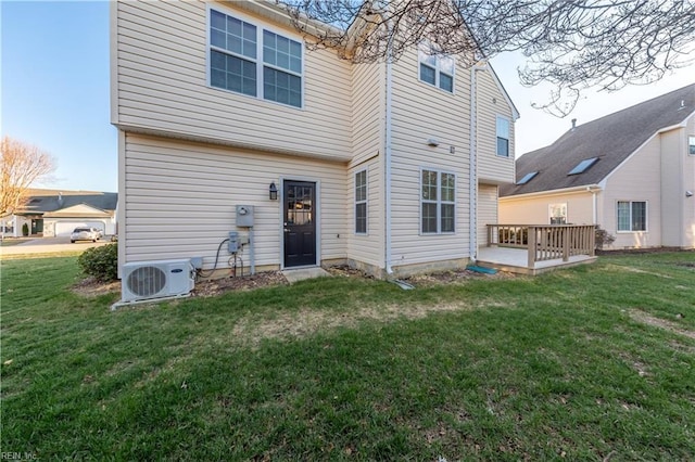 rear view of property with a lawn, ac unit, and a wooden deck