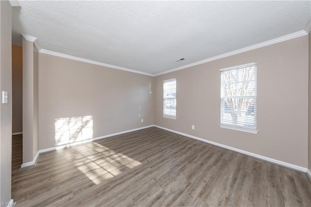 spare room featuring hardwood / wood-style floors, a textured ceiling, and crown molding