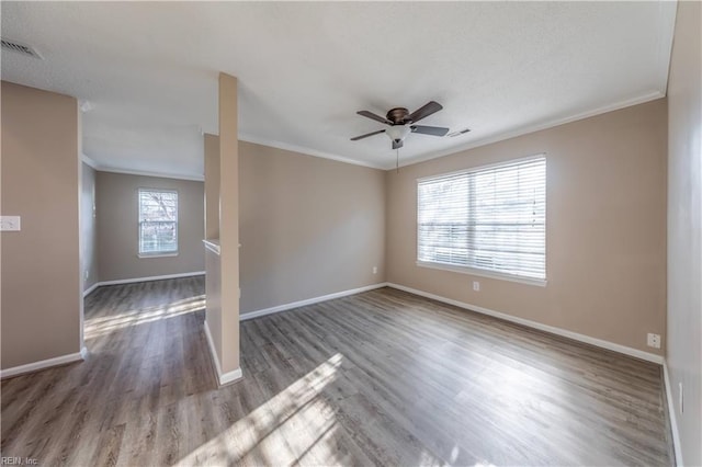 empty room featuring ceiling fan, hardwood / wood-style floors, and ornamental molding