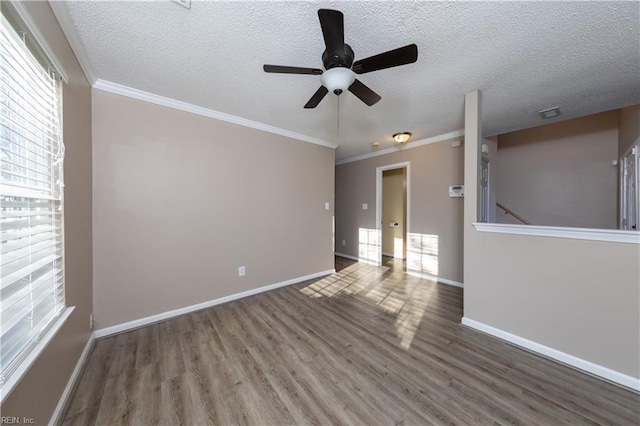 empty room with hardwood / wood-style floors, a textured ceiling, ceiling fan, and ornamental molding