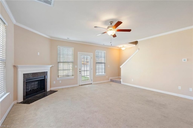 unfurnished living room featuring light carpet, a healthy amount of sunlight, ceiling fan, and crown molding