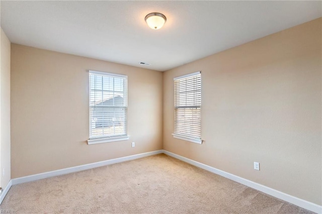 carpeted empty room with a wealth of natural light