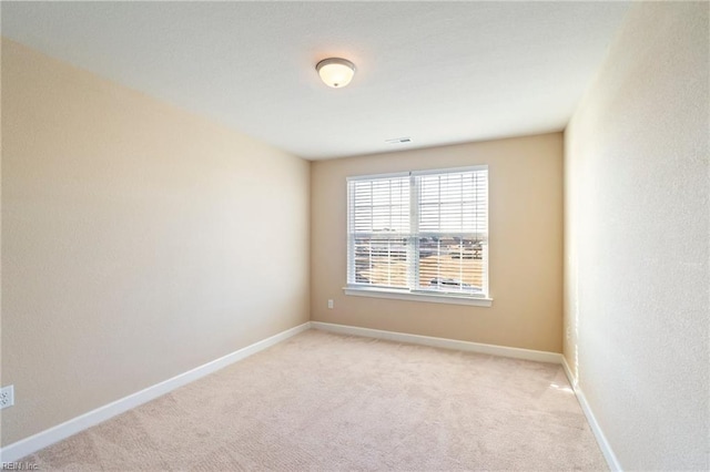 unfurnished room with light carpet