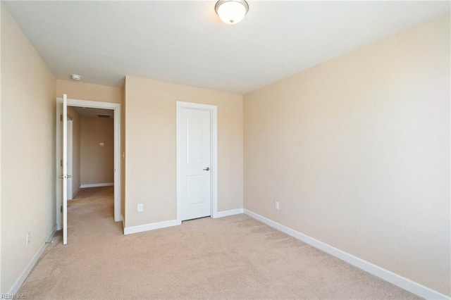 unfurnished bedroom featuring light colored carpet