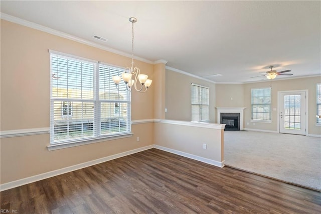 interior space featuring dark hardwood / wood-style flooring, ceiling fan with notable chandelier, and ornamental molding