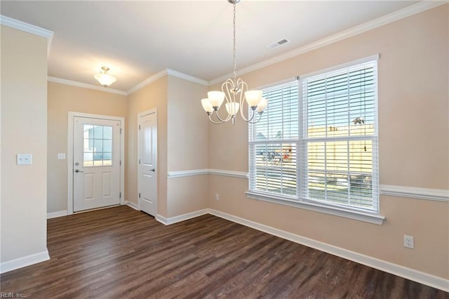 unfurnished dining area featuring dark hardwood / wood-style flooring, ornamental molding, and an inviting chandelier