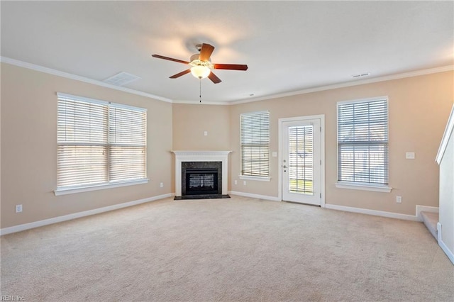 unfurnished living room featuring a premium fireplace, ornamental molding, and light carpet