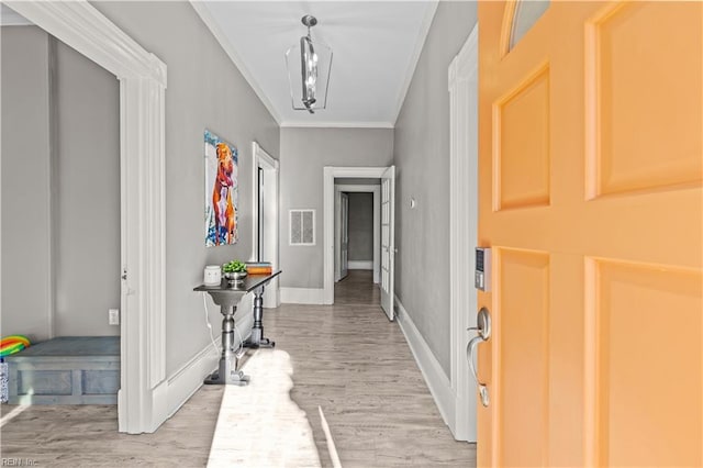 foyer entrance featuring wood-type flooring and ornamental molding