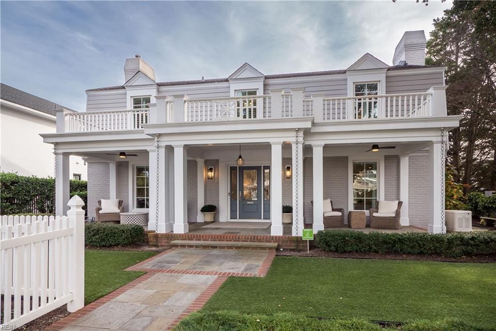 view of front of house with an outdoor living space, a balcony, a front lawn, and a porch