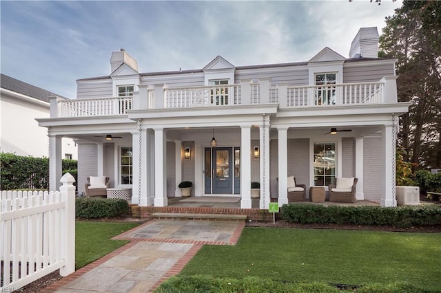 view of front of house with an outdoor living space, a balcony, a front lawn, and a porch