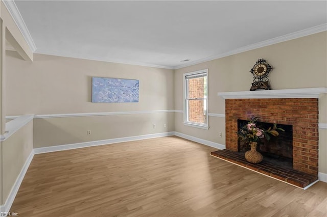 unfurnished living room with wood-type flooring, ornamental molding, and a brick fireplace