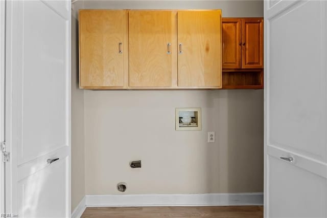 washroom with cabinets, washer hookup, light wood-type flooring, and electric dryer hookup