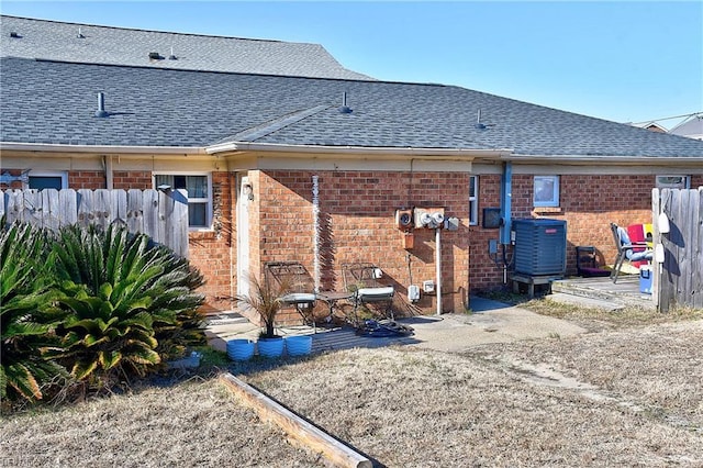 back of house featuring central AC