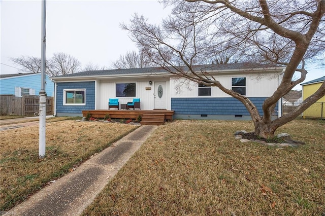 ranch-style house with a wooden deck and a front lawn