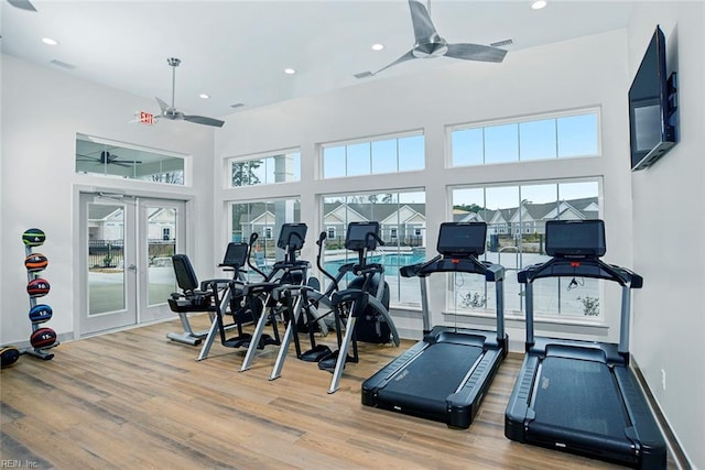 gym with ceiling fan, wood-type flooring, and french doors