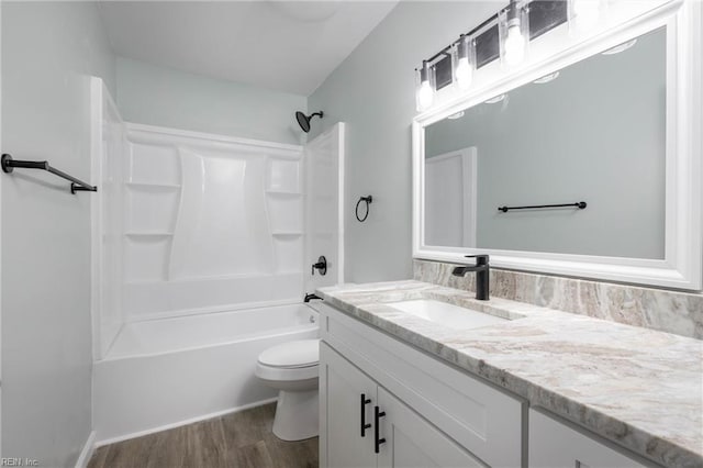 full bathroom with hardwood / wood-style floors, vanity, toilet, and bathtub / shower combination