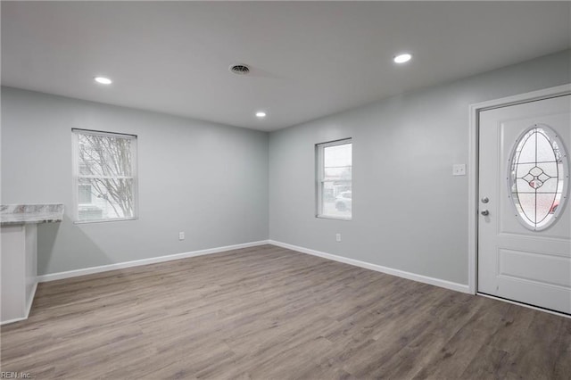 foyer entrance with light hardwood / wood-style floors