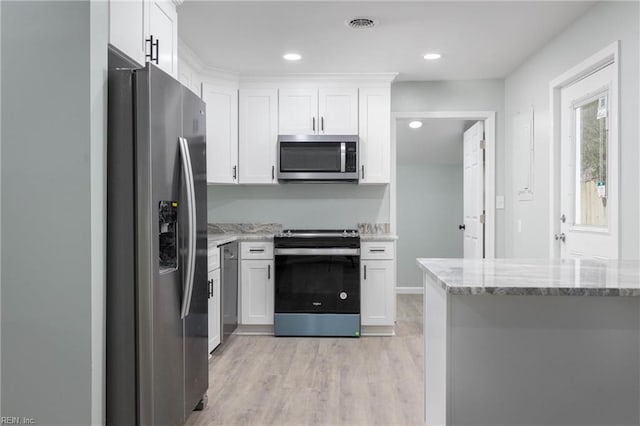 kitchen featuring white cabinets, light hardwood / wood-style floors, light stone counters, and appliances with stainless steel finishes