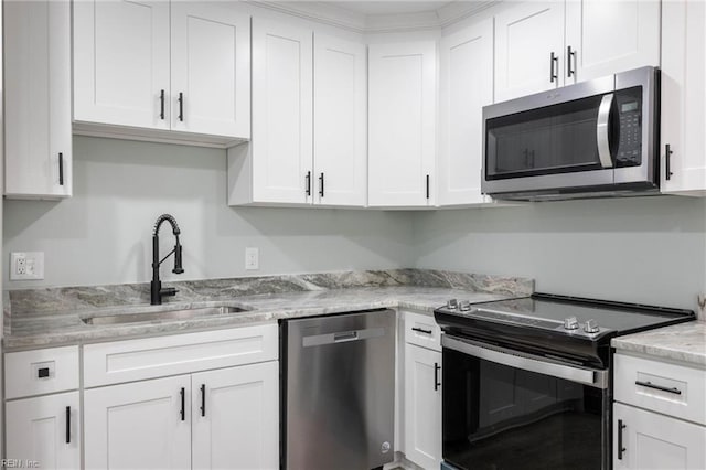 kitchen featuring light stone countertops, white cabinetry, sink, and appliances with stainless steel finishes