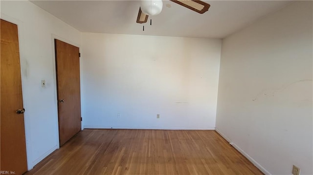 empty room with hardwood / wood-style flooring and ceiling fan